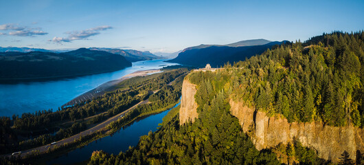Aerial panoramic view of Columbia River Gorge with historic Vista House in golden evening light at sunset, Oregon, Pacific Northwest, USA © JFL Photography