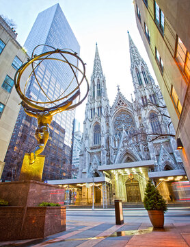 New York City, USA; 28th December 2011: The famous Atlas statue by Lee Lawrie in the Rockefeller Center in Midtown Manhattan with St. Patrick's Cathedral in the background