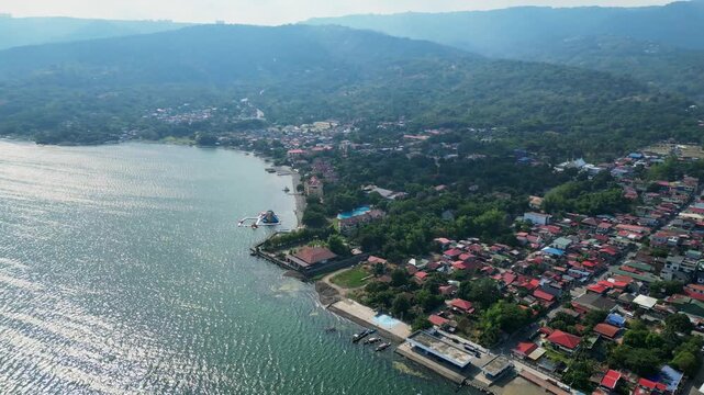 Drone aerial footage of Club Balai Isabel resort and provincial houses beside Taal Lake in Batangas Philippines.
