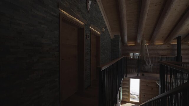 Camera slowly panning inside a luxurious and rustic mountain log cabin with stone walls and wood beams