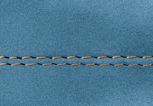 Professional double seam on Blue suede leather garment close-up