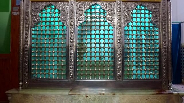 Green metal gate and tiled floor inside traditional structure creating architectural detail and cultural documentary scene perfect for travel stock video footage.