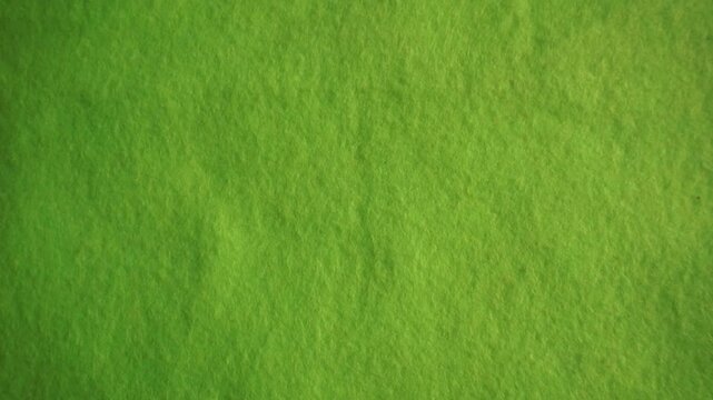 Close-up of green flannel fabric texture with soft cotton surface and natural textile pattern. Abstract green fabric background with detailed fiber texture, ideal for wallpaper, product background, te