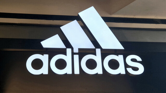 White Adidas logo with three slanting bars and lowercase text on a black storefront sign. Picture taken on May 27, 2026 in Bucharest, Romania.