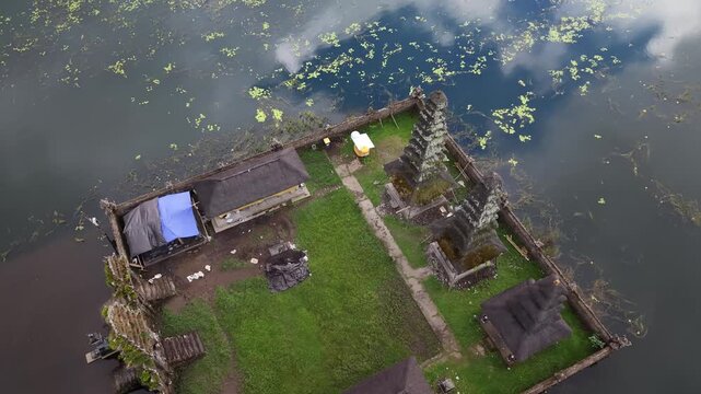Aerial view of Pura Segara Kidul Temple partially submerged in Lake Tamblingan, Bali, Indonesia