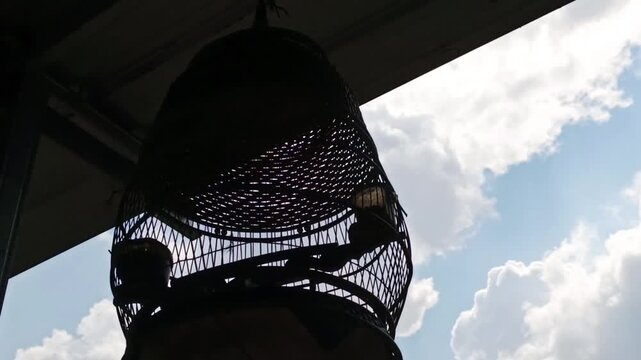 silhouette of a bird cage in front of the garage