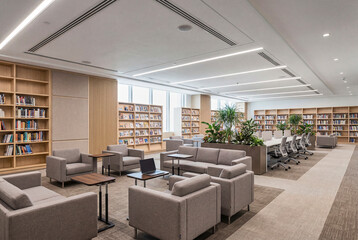 Fototapeta premium Warm Public Library Interior With Wooden Shelves and Flexible Reading Space for Quiet Academic Themes
