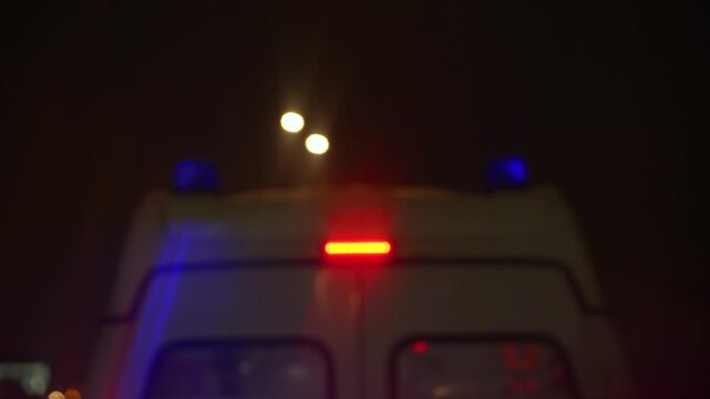 Emergency Vehicle Lights Blinking at Night, Signaling Urgent Movement Through Darkness