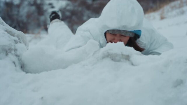 White scientist struggling under deep snow at frozen cliff edge, wearing white protective suit and helmet, breath visible, desperate grip on frostcovered ridge, suspenseful cold survival scene