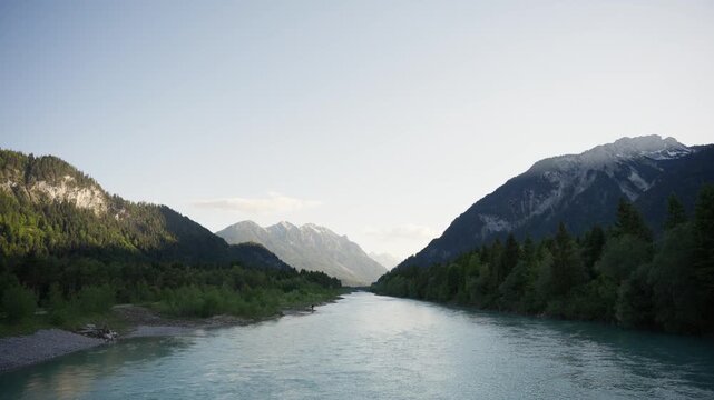 Majestic Lech River Flowing Through Lechtal Valley with Towering Alpine Mountains and Lush Green Forests