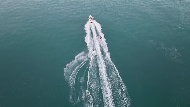 Drone Shot of Wakeboarder Carving Turquoise Sea Water