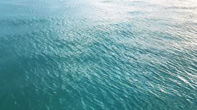 Drone flying low over the water of the ocean