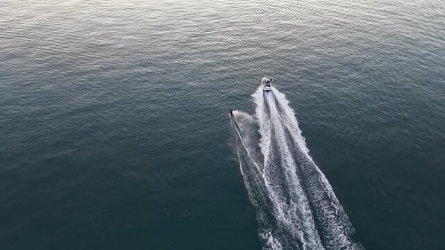 Speed Boat Towing Wakeboarder in Crystal Clear Blue Water