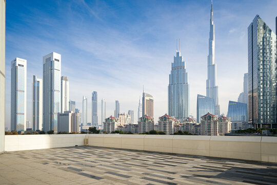 Dubai, United Arab Emirates - 22 April 2023: View of the Burj Khalifa and the modern skyline of Downtown Dubai from a rooftop terrace under a clear blue sky.