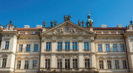 Obraz premium The stunning Baroque building stands majestically against a clear blue sky in Europe with ornate architecture and statues on top.