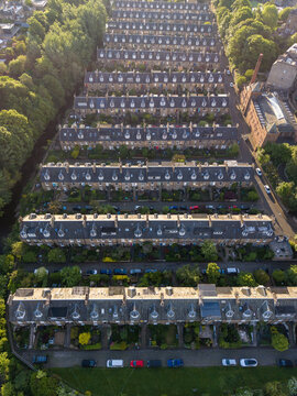 Aerial view of rows of historic terraced houses and lush green trees in a residential neighborhood Edinburgh, Scotland, United Kingdom.