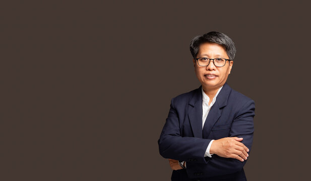 Confident Female Executive Standing With Arms Crossed