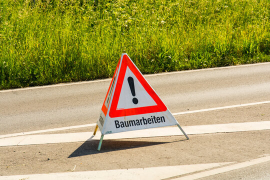 Warnschild auf der Strasse - Baumarbeiten, Gartenpflege