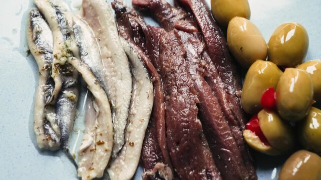 Traditional Catalan snacks for wine, beer and vermouth include green olives and anchovies. High quality 4k footage