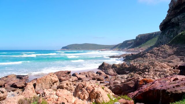 Rugged coastal geology and clear blue water of waves at Robberg Nature Reserve