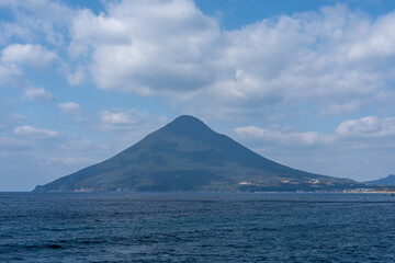 Fototapeta premium Kaimondake Volcano Rising from the Blue Sea at Ibusuki