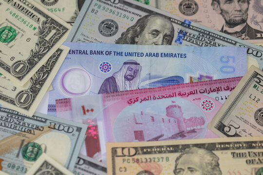 United Arab Emirates dirham and US dollar banknotes in a financial cash money background concept
