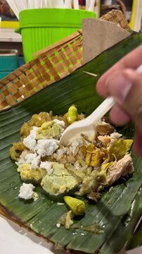 Nasi Liwet, authentic food from Solo, Surakarta Central Java that consist of steam rice, spicy vegetables, slices of chicken, eggs, and white sauce
