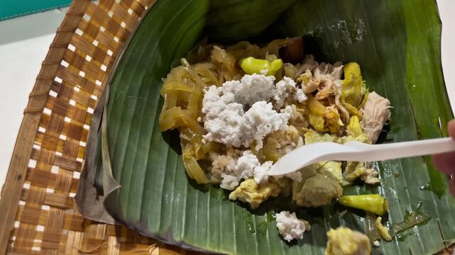 Nasi Liwet, authentic food from Solo, Surakarta Central Java that consist of steam rice, spicy vegetables, slices of chicken, eggs, and white sauce