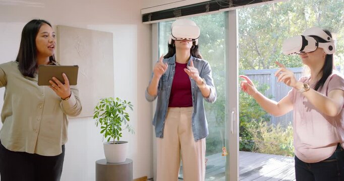 Asian women guiding users, reading tablet while users with headsets reaching grabbing for home demo