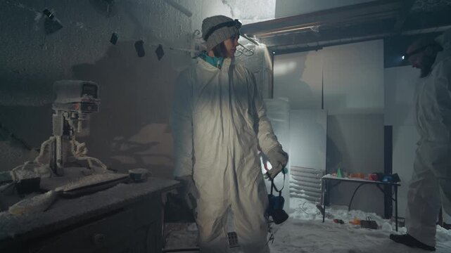 Sample collection process. Assistant carefully collects contaminated sample from freezer. Assistant methodically retrieves contaminated specimen from freezer while documenting with camera