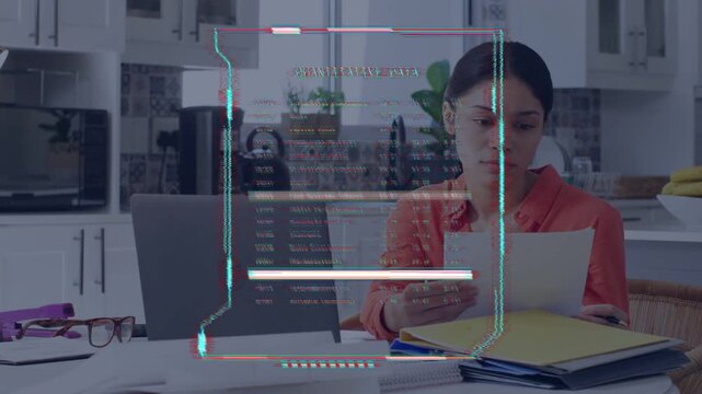Woman sorting papers at kitchen table, HUD fading in overlaying and scanning finance data for bills