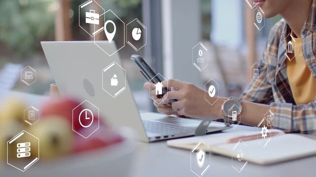Man bringing phone into view, tapping, glancing at laptop, hex UI icons overlaying for tech demo