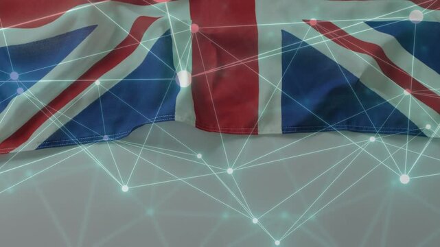 Camera zooming, draped Union Jack shifting while teal network nodes pulsing, showing digital link