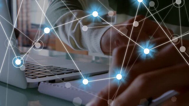 Man hovering then pressing keys causing pulsing node overlay while writing on notepad for tech work