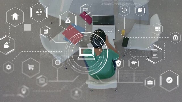 Man typing on laptop in tech study area, activating HUD analytics and hex icons visualizing network