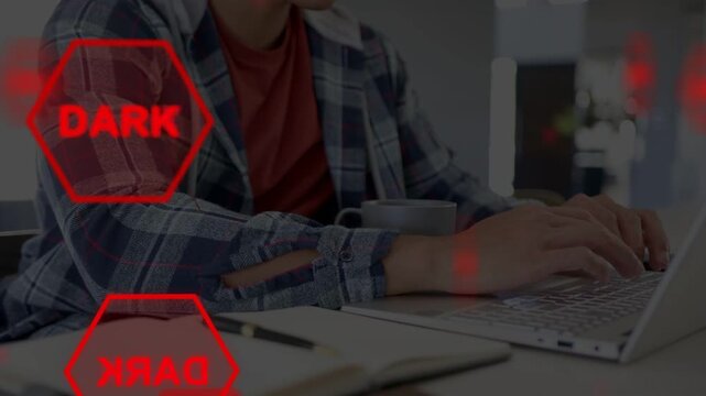 Man typing on laptop and activating red UI overlays for technology demo, hexagons moving over desk