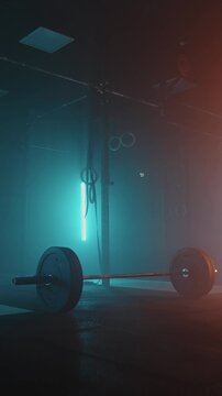 Athletes engaged in intense functional training with barbell weightlifting and gymnastic rings in a dimly lit fitness facility emphasizing strength and endurance development