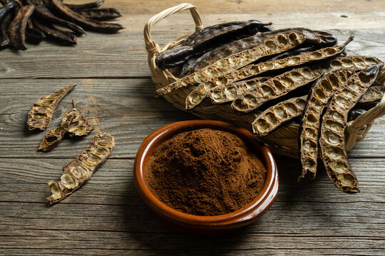 Organic Carob Pods on Rustic Background
