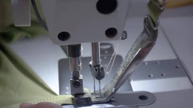 Close-up of a professional sewing machine stitching fabric, highlighting the intricate process of textile creation and craftsmanship