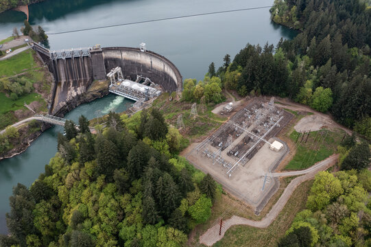 Aerial drone picture of Lake Merwin dam and electrical substation on the Lewis River in Washington, USA. Hydroelectric power plant infrastructure surrounded by forest in Pacific Northwest landscape