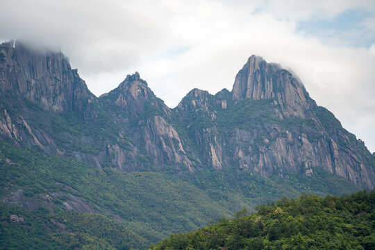 The majestic rocky peaks of Lingshan Mountain rise above the green forest landscape in Shangrao China