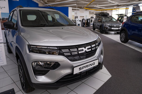 new glossy Dacia Spring electric vehicles dealership, city car, Branding detail, eco-friendly compact cars SUV Dacia, zero emission, auto industry, Frankfurt, Germany