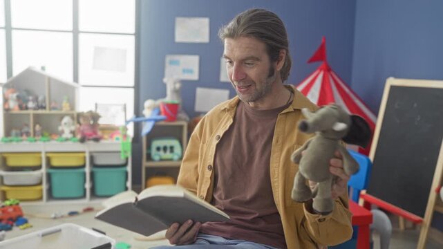 Man reading book and holding stuffed elephant with hand in preschool playroom building; warmth connection learning.