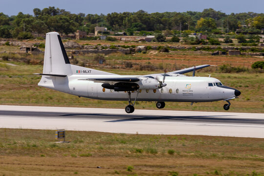 Luqa, Malta - July 11, 2007: Miniliner Fokker F-27-500 Friendship (REG: I-MLXT) last moments before touch down on runway 32. 