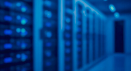 Fototapeta premium Blurred computer server racks in a modern data center representing digital information storage and high-speed networking.