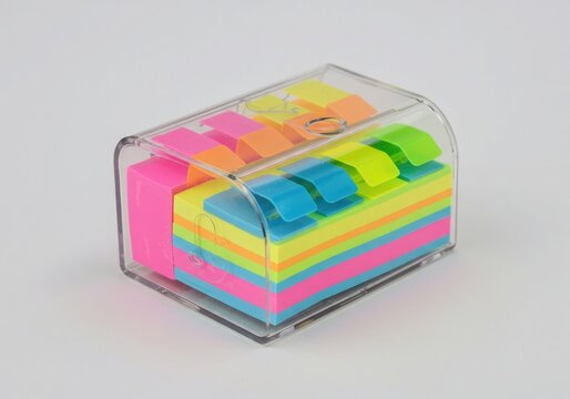 Colorful Sticky Note Flags in Clear Plastic Dispenser Box on White Background for Office Organization