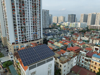 Modern apartment towers and rooftop solar panel system along Tam Trinh street in densely populated Hanoi Vietnam. © Hanoi Photography