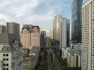 Fototapeta premium Highrise residential and office buildings lining Me Tri street in modern urban district of Hanoi Vietnam during late afternoon.