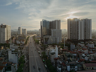 Obraz premium Sunset view of Minh Khai road lined with modern apartment towers and busy traffic in Hai Ba Trung district Hanoi Vietnam.