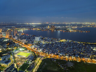 Obraz premium Night aerial panorama of Vo Chi Cong Street and West Lake with illuminated urban skyline in Hanoi, Vietnam.